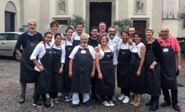 René Redzepi and Massimo Bottura with the staff at Refettorio Ambrosiano Milan, 2015