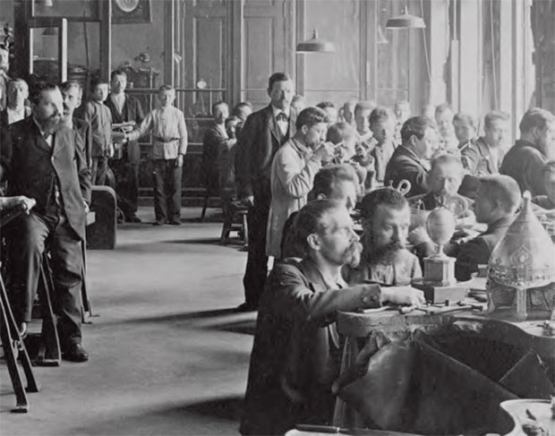 Michael Evamplevitch Perchin’s workshop in St Petersburg, 1902. The Rothschild Egg is on the table in the foreground, being worked on by two goldsmiths. Perchin, standing to the left in the photograph, was a Fabergé workmaster. From Going Once: 250 Years Of Culture, Taste And Collecting At Christie's