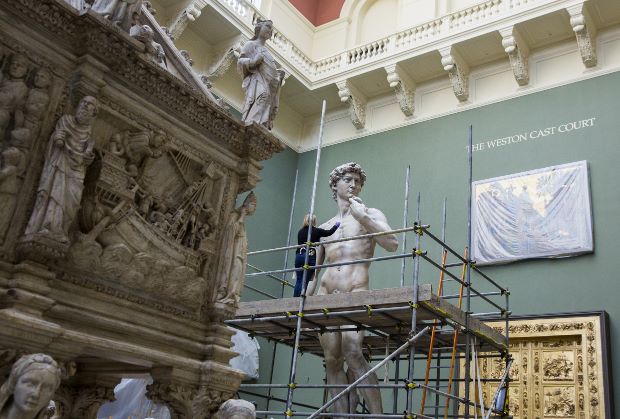 Conservator Johanna Puisto dusts the cast of Michelangelo's David post conservation, Nov 2014 in the Weston Cast Court