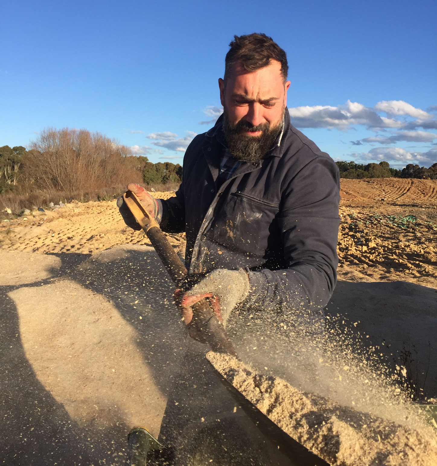 Marco Chiandetti digging a fire pit in the summer of 2017 - photo by Ingrid Morley